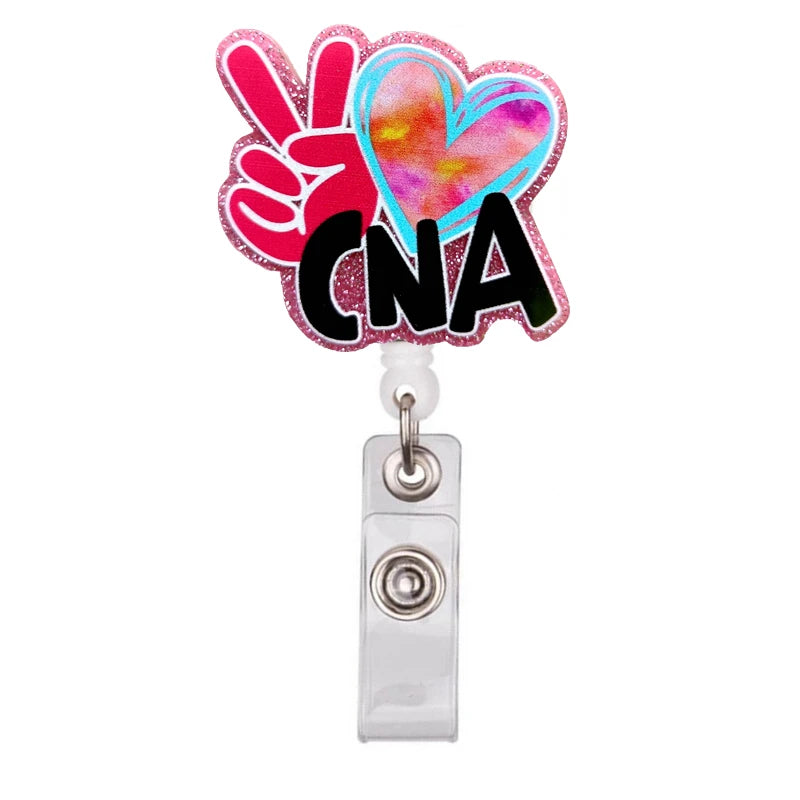 A pink and blue heart shaped badge reel holder with a pink hand gesture and the letters CNA