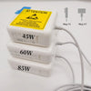 Three stacked white magnetic power adapters labeled 45W, 60W, and 85W with an attention warning sticker.