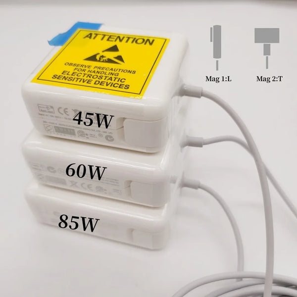 Three stacked white magnetic power adapters labeled 45W, 60W, and 85W with an attention warning sticker.