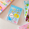 A close-up of a cute blue bottle labeled 500ml with characters and text on a memo pad.