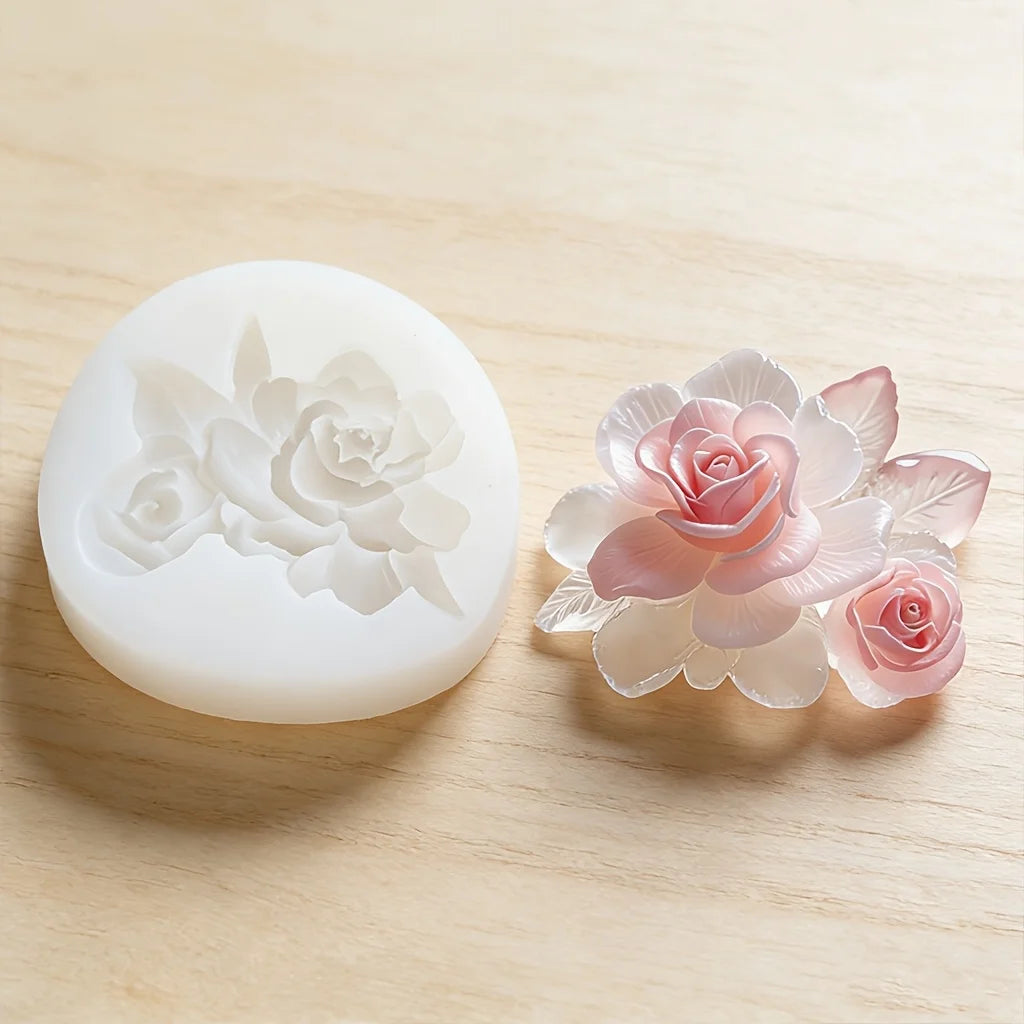 A set of pressed flower wax seals in pale pink and white on a wooden surface.