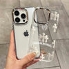 A hand holds a clear holographic gradient phone case for an iPhone, featuring a white background and cross designs.