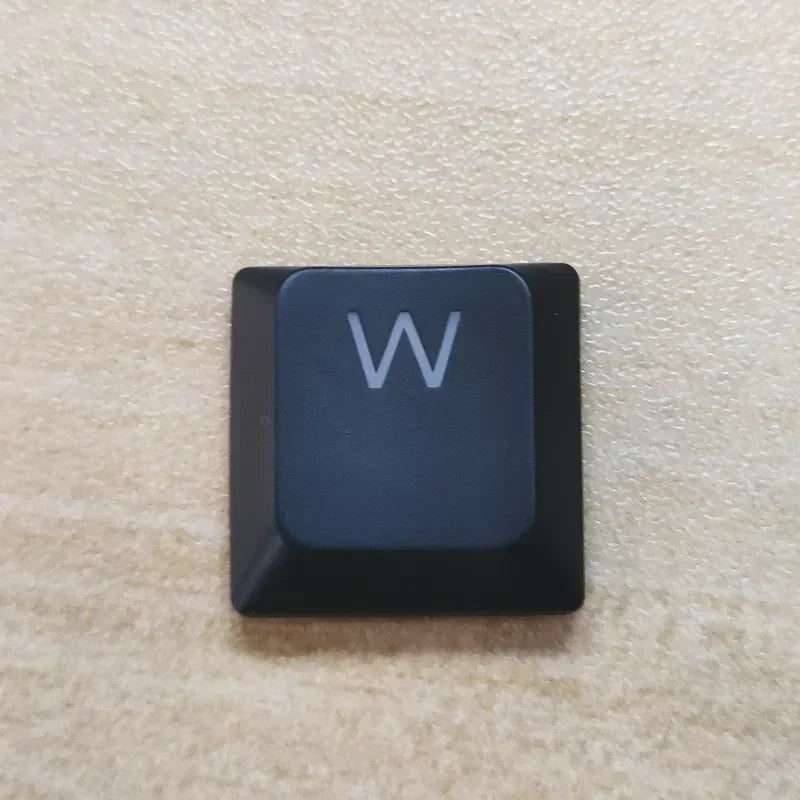 A close-up view of a dark blue mechanical keyboard keycap with the letter W on it.