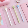 A collection of cute cartoon fruit gel pens in various pastel colors, including pink, yellow, green, and blue.