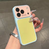 A hand holds a light blue phone case with a yellow back, featuring multiple camera lenses and decorative nail art.
