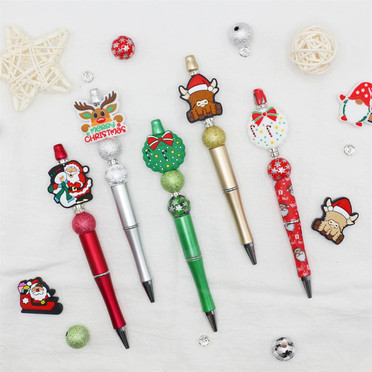 A set of decorative beaded ballpoint pens featuring Christmas and festive designs.