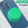 Emerald green MagSafe phone grip stand with silicone cover shown on a smartphone.