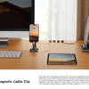 Magnetic cable clips used to organize charging cables and wires on a wooden desk surface.