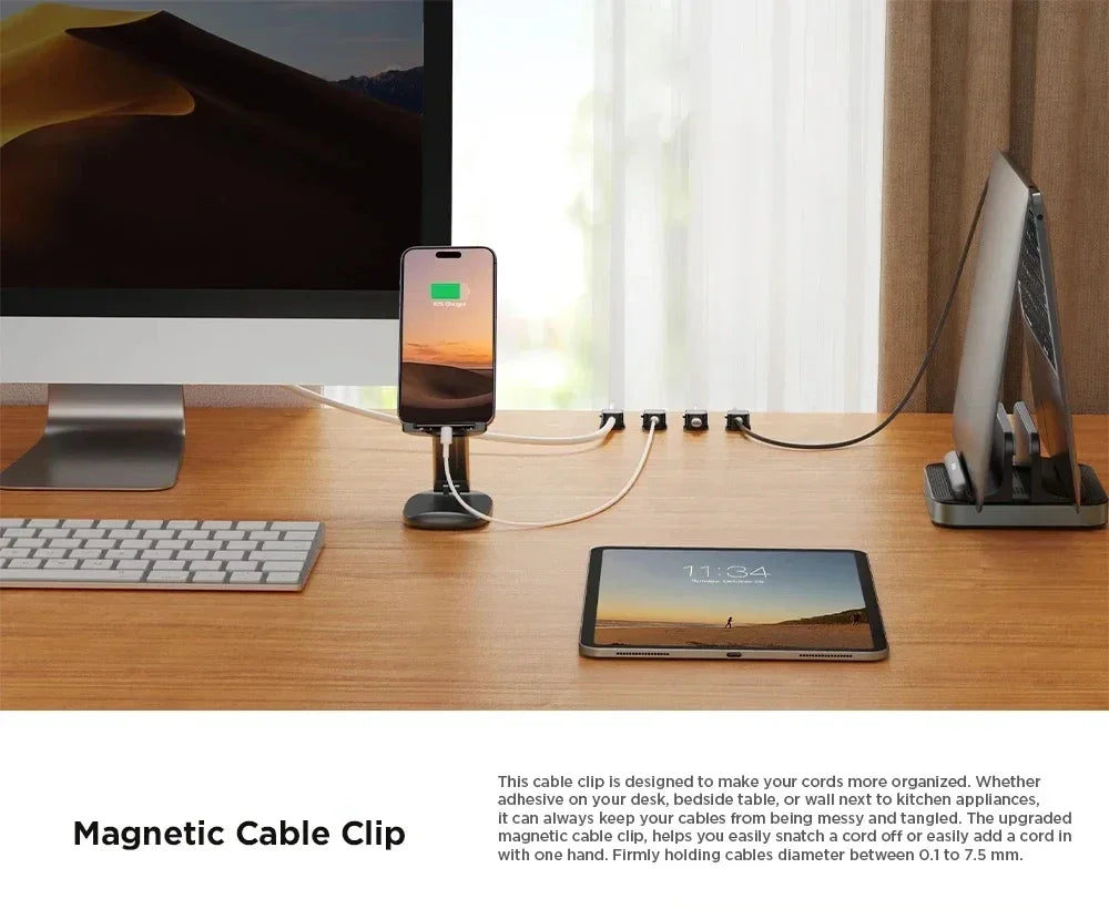 Magnetic cable clips used to organize charging cables and wires on a wooden desk surface.