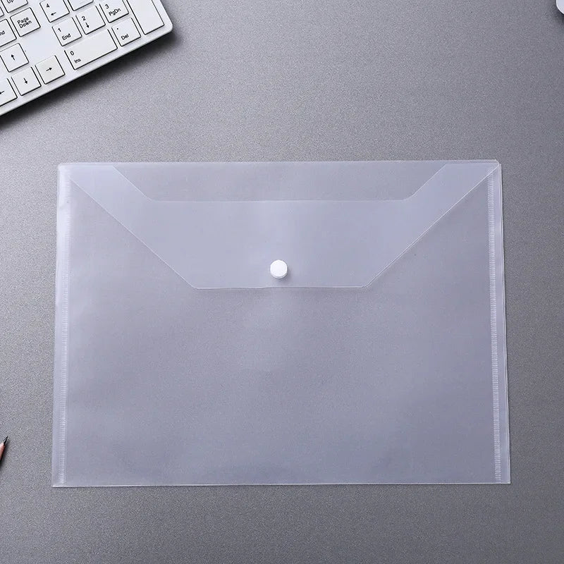 A clear plastic document pouch with a sealed flap and a small white button is shown on a gray surface.