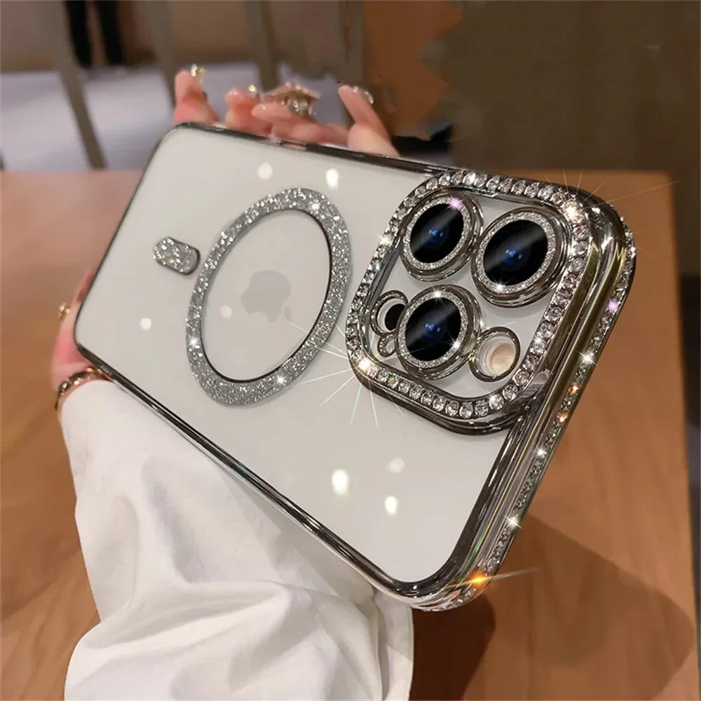 A hand holds a clear phone case decorated with glitter diamonds and multiple lenses.