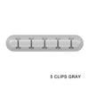 A gray silicone cable organizer with five clips.