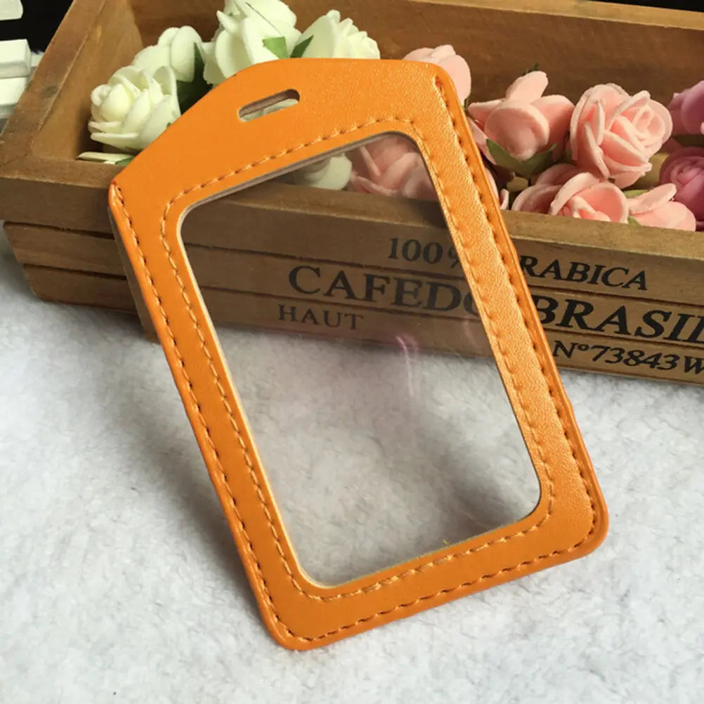 Orange PU leather ID card holder with a leather strap resting on a wooden box.