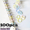 A collection of 100 random color reusable plastic binding rings in various shades of yellow, pink, and blue are displayed on 