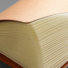 A close-up view of an A5 Kraft cover notebook with 36 sheets per book, showing the layered pages.