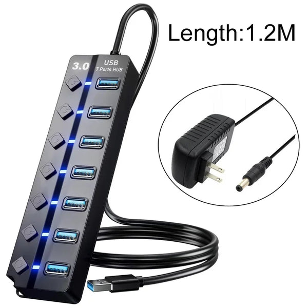 Black USB 3.0 hub with seven ports and an LED indicator cable coiled on a white background.