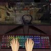 A close-up shot of an RGB wired gaming keyboard with 104 keys and a hand resting on the keys.