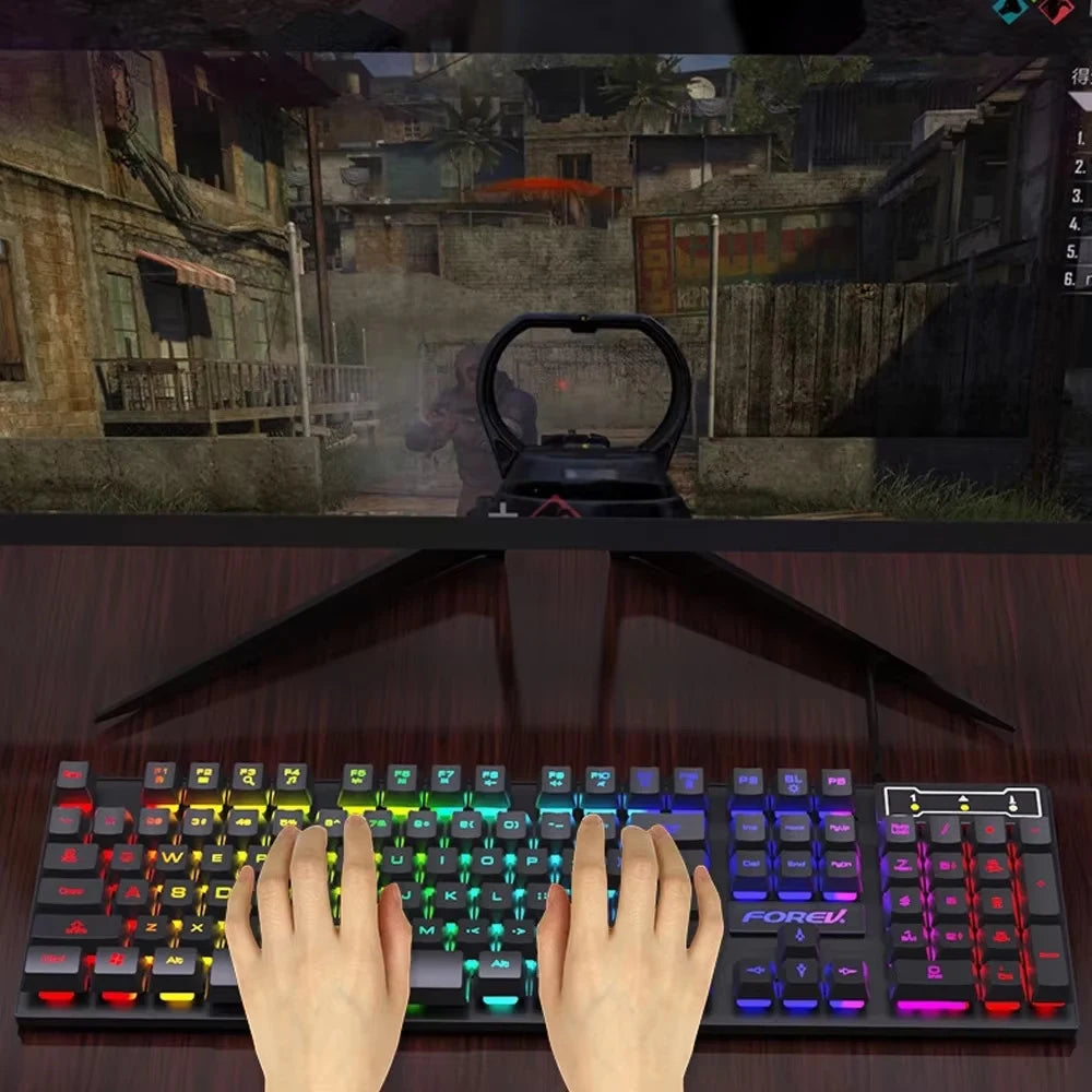 A close-up shot of an RGB wired gaming keyboard with 104 keys and a hand resting on the keys.
