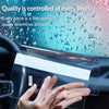 A hand is applying a clear film protector to a car navigation screen.
