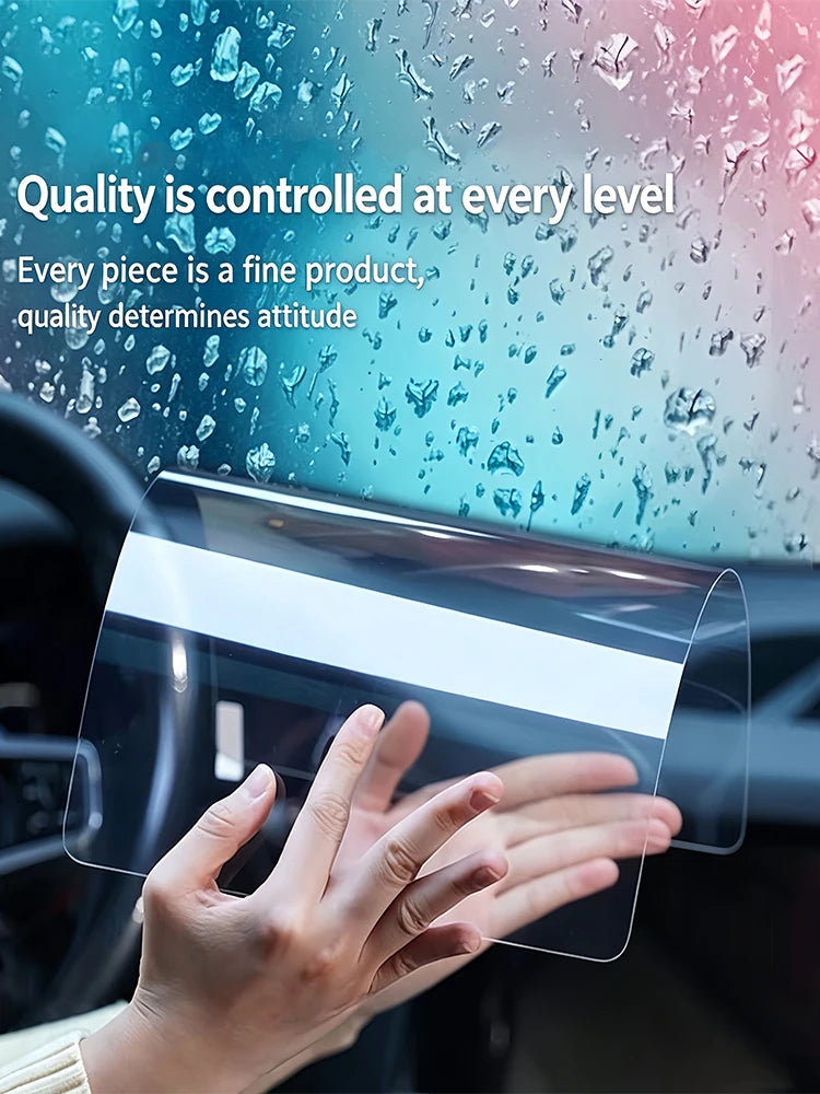 A hand is applying a clear film protector to a car navigation screen.