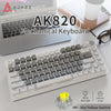 A white mechanical keyboard is shown next to a laptop, highlighting its layout and yellow switch.
