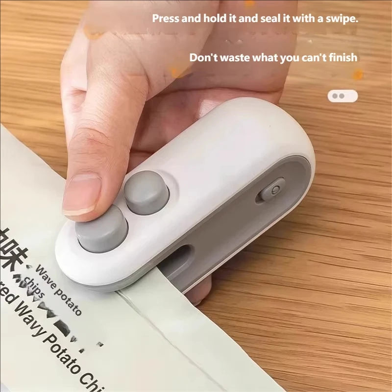A hand holds a white handheld heat sealer device, demonstrating how to press and hold it and seal with a swipe.