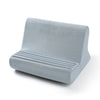 A light gray multi-angle adjustable tablet and phone holder with a padded, contoured design.