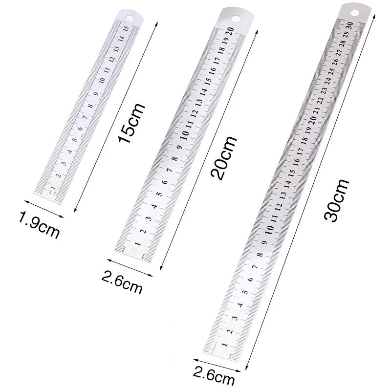 A set of precision stainless steel measuring rulers showing various centimeter and inch markings.