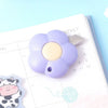 A purple floral design letter opener and paper cutter resting on a white monthly planner page.