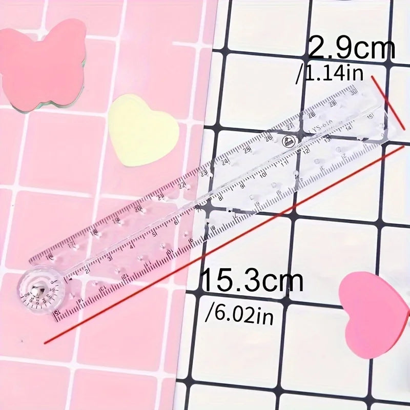 Regla plegable de acrílico transparente junto a recortes en forma de corazón rosa, mostrando su tamaño y marcas.