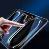 A hand touches a smartphone screen displaying a polished glass surface with light trails.