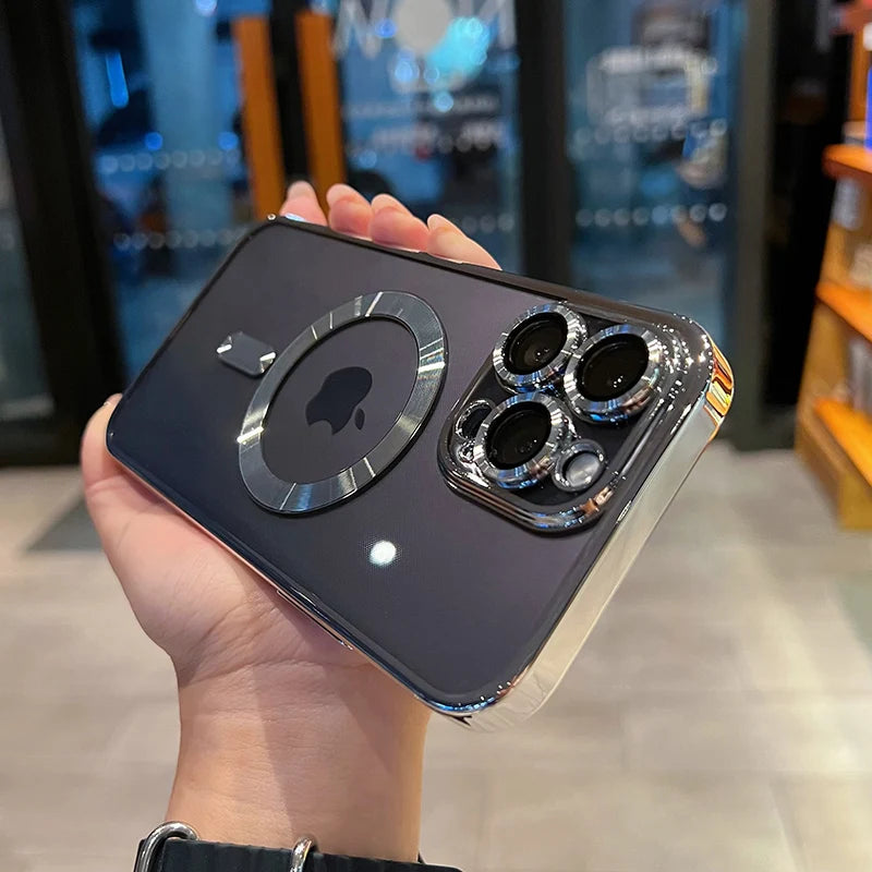 A hand holds a dark iPhone with a magnetic clear case featuring a plated finish and multiple camera lenses.