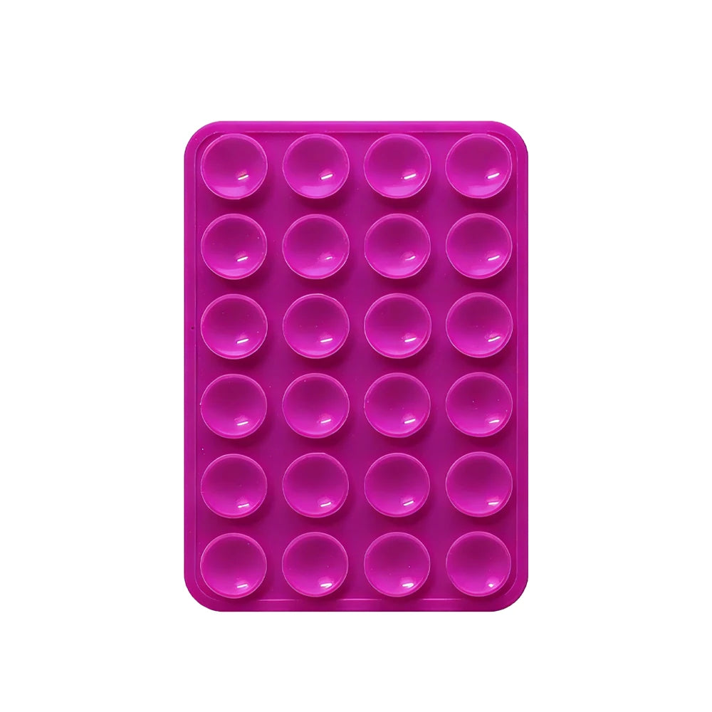 Sujetador de teléfono de silicona rosa con múltiples orificios circulares para montar dispositivos.