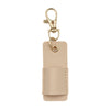 A light beige leather pen holder keychain with a gold-toned metal clip.