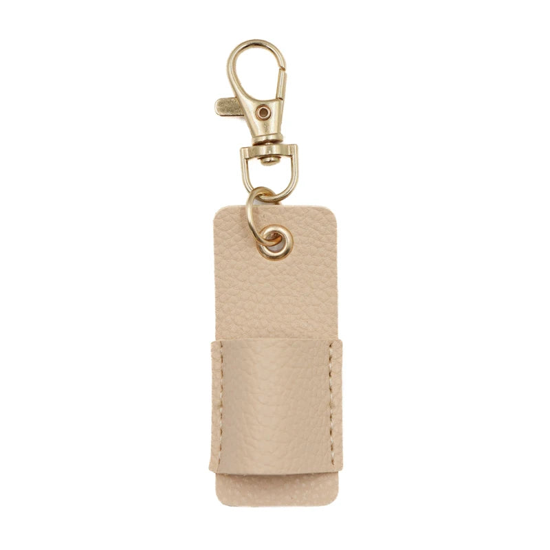 A light beige leather pen holder keychain with a gold-toned metal clip.