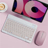 A white portable Bluetooth keyboard is shown next to an iPad displaying a colorful screen on a pink surface.