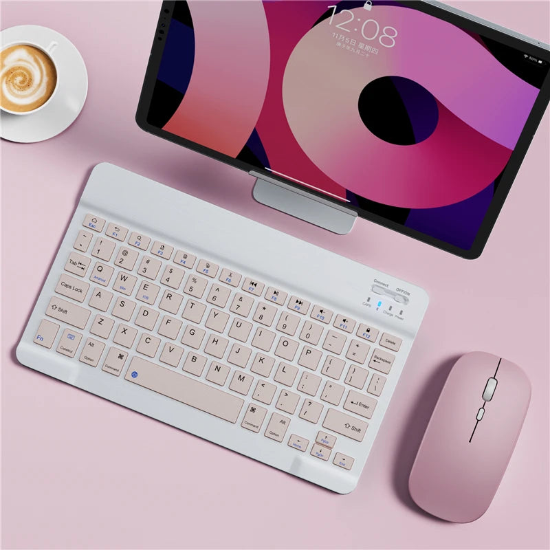 A white portable Bluetooth keyboard is shown next to an iPad displaying a colorful screen on a pink surface.