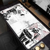 A large mouse pad featuring a black and white illustration of a character with long hair and a sword on a dark surface.