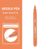 An orange needle pen with a reddish brown ink cartridge and a gold tip.