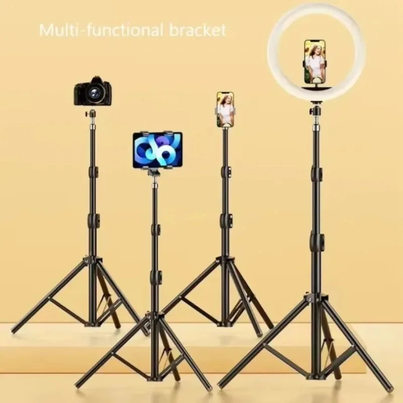 A multi-functional tripod setup showing a camera, a smartphone mount, and a ring light on three separate stands.