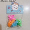 A set of four colorful silicone pencil grips for kids with a cartoon design.