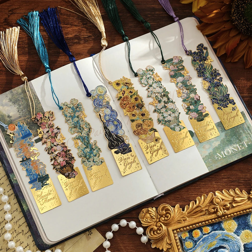 Vintage artistic metal bookmark with tassel featuring floral designs and gold accents.