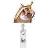 A close-up photo of a tabby cat wearing a light-colored fabric around its head, positioned above an ID badge holder.