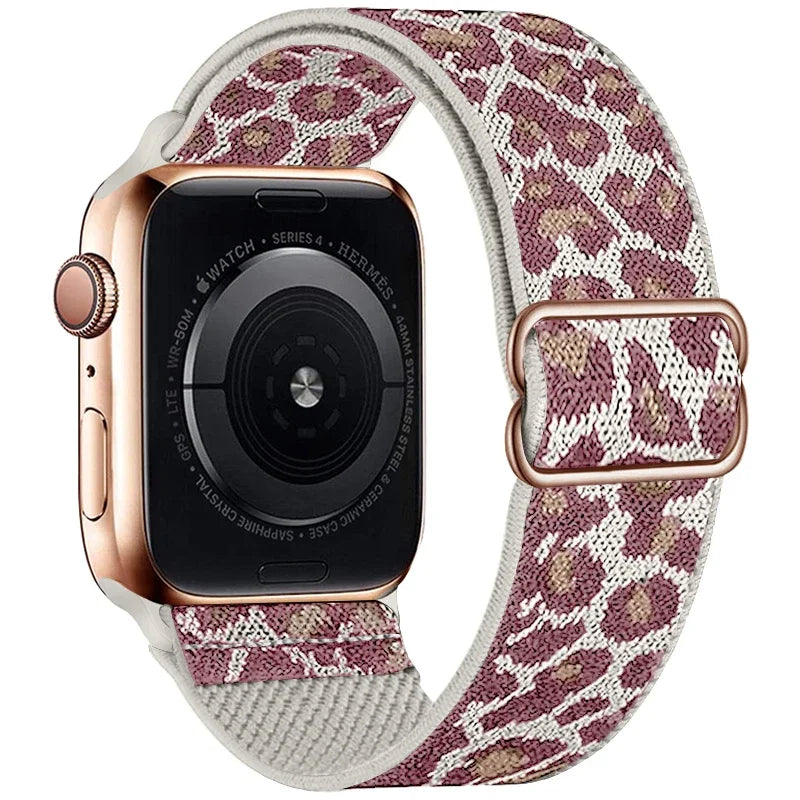 A close-up of an Apple Watch with a rose gold case and a leopard print nylon band.