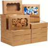 A stack of kraft paper gift boxes containing various baked goods like cookies and bread.