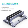 A silver aluminum alloy dual slot vertical laptop stand with an adjustable width.
