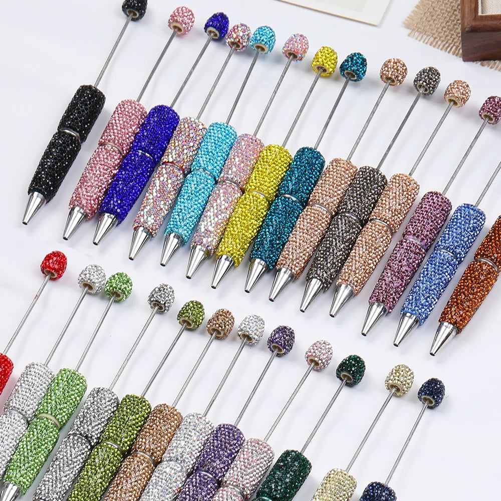 A collection of 20 rhinestone beaded pen accessories in various colors and finishes displayed on a white background.