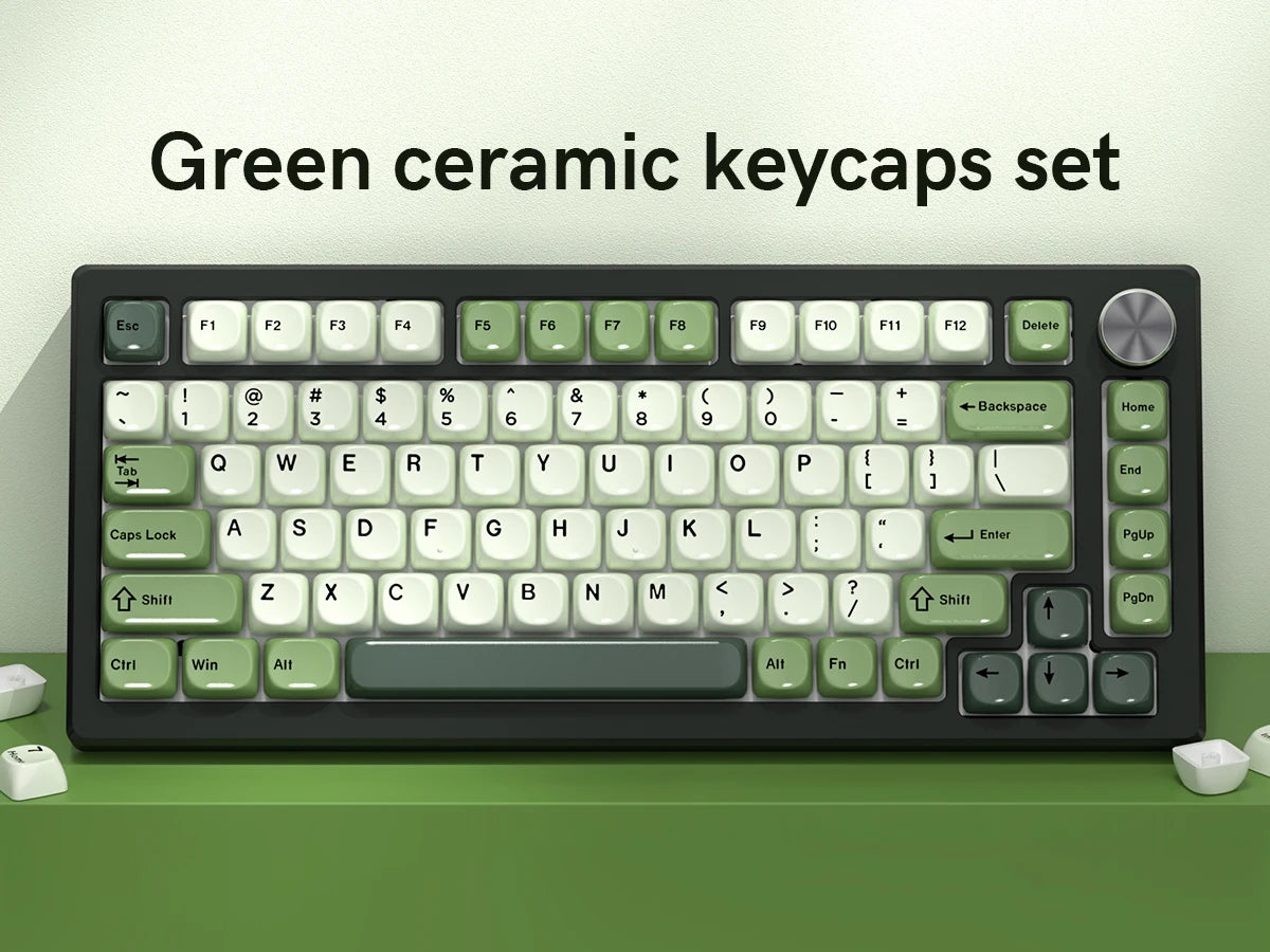 A set of bright green ceramic keycaps for a mechanical keyboard displayed on a green desk.