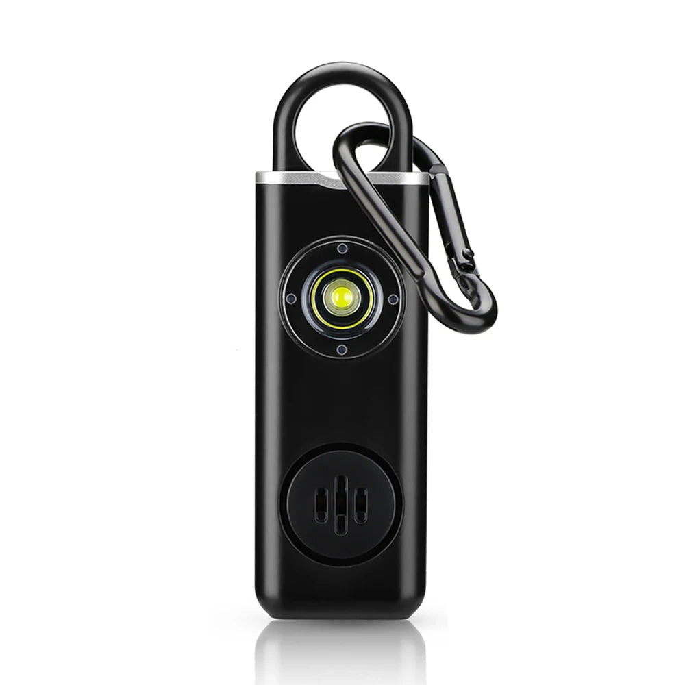 A black personal safety alarm device with a silver casing and a black lanyard attached.