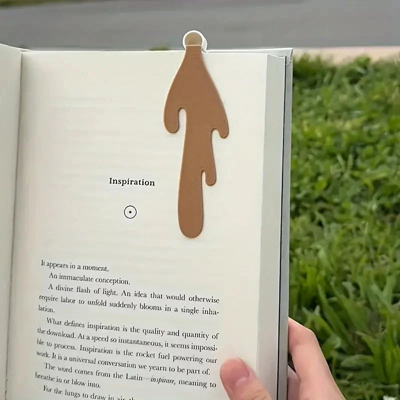 A page from a book features the word Inspiration and a silhouette of a hand.